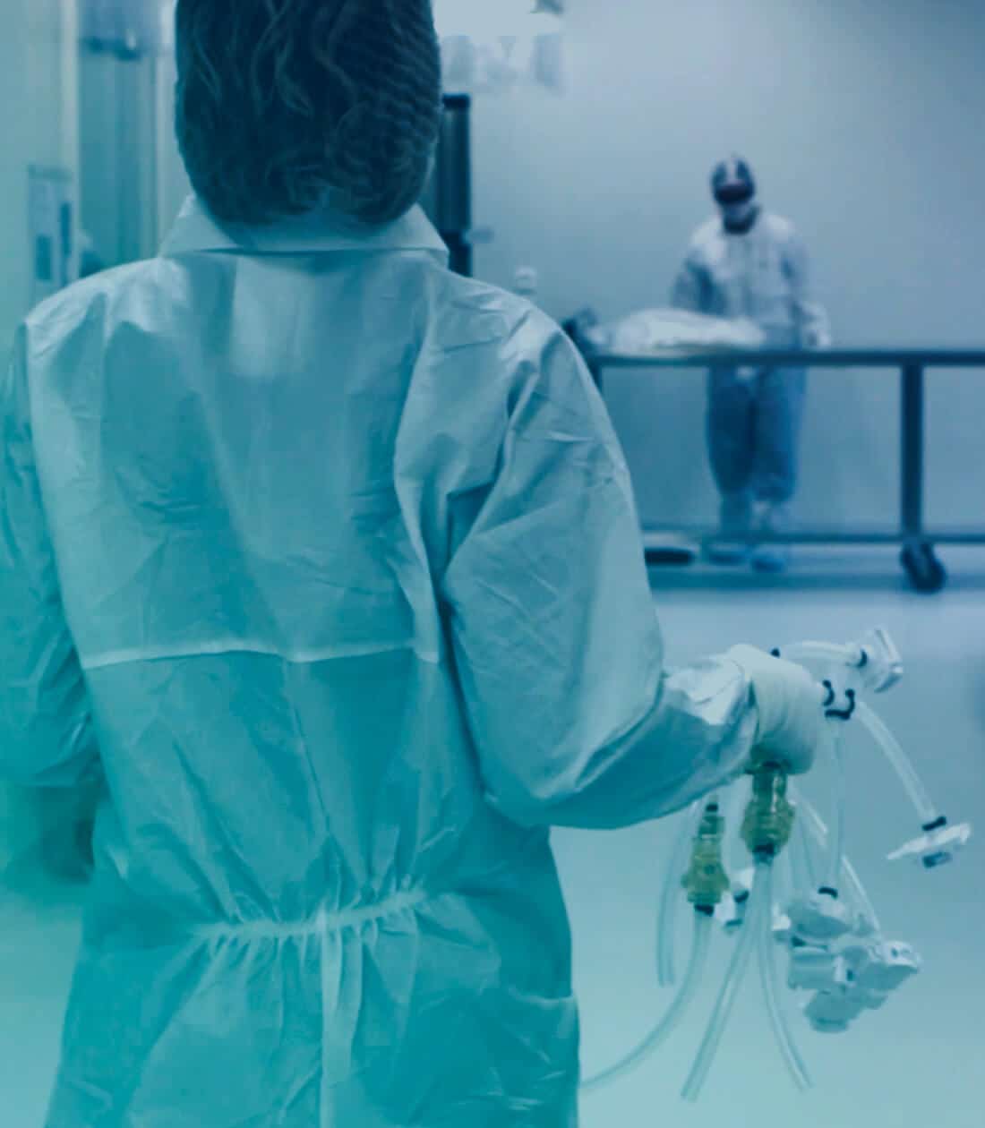 Photograph of an operator in sterile clothing holding assemblies